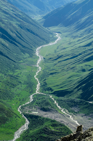 View of the mountain valley with a lake, two streams that form the river and climbing base camp on...