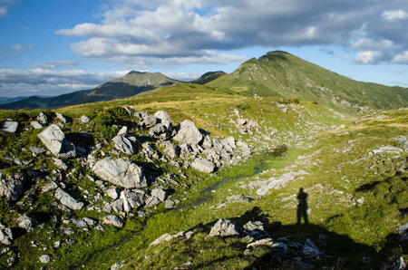 Mountain landscape with a shadow of the photographer on the foregroundの写真素材