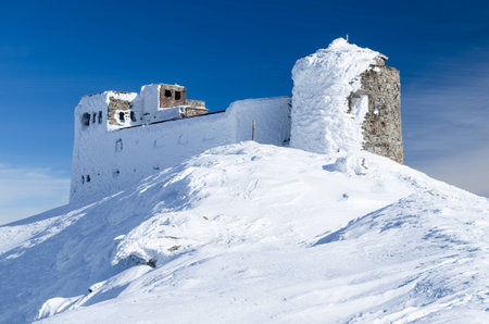 Winter view of abandoned observatory atop the mountain Pip Ivan in Ukrainian Carpathians. It goes through the process of reconstruction nowの写真素材