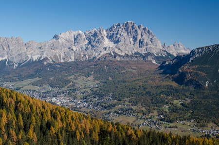 View of the rocky mountain ridge and a small mountain town in the valleyの写真素材