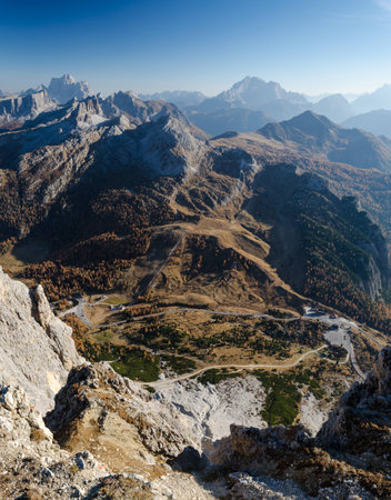 Aerial panoramic view of rocky mountains and mountain road in the valleyの写真素材