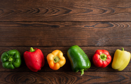 several peppers of different colors on a wooden backgroundの写真素材