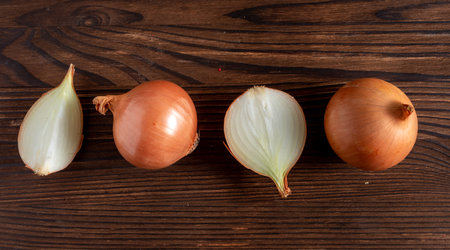 raw cut and whole onion on wooden table close-upの写真素材