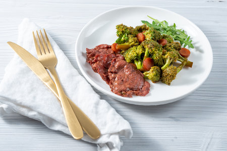 Beef Steak with Broccoli and Carrot on white plateの写真素材