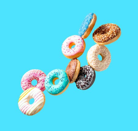 Flying donuts isolated on blue background. creative food concept. 3D Renderingの写真素材