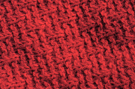 Red knitted wool texture closeup. Abstract background and texture for design.の写真素材