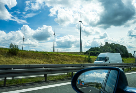 wind turbines on the side of the highway visible from a car windowの写真素材