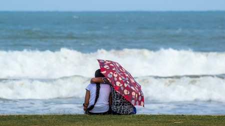 The guy embraces the girl on the beach. Couple in love.の写真素材