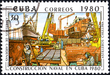 UKRAINE - CIRCA 2017: A postage stamp printed in Cuba shows Shipyards chullima from series Constructing of ships on Cuba, circa 1980のeditorial素材