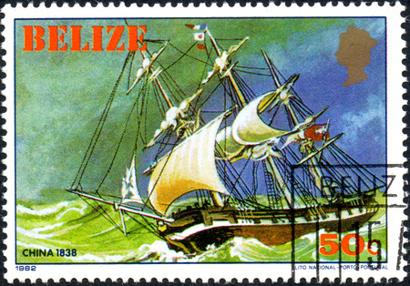 UKRAINE - CIRCA 2017: A postage stamp printed in Belize shows sailing ship China 1838, from the series Historic ships, circa 1982のeditorial素材