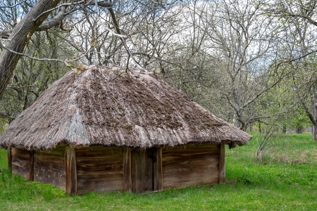 National Museum Pirogovo in the outdoors near Kiev. Ancient rural Ukrainian old wooden building with a thatched roof, spring landscape in the old village of national architecture, Ukraine.のeditorial素材