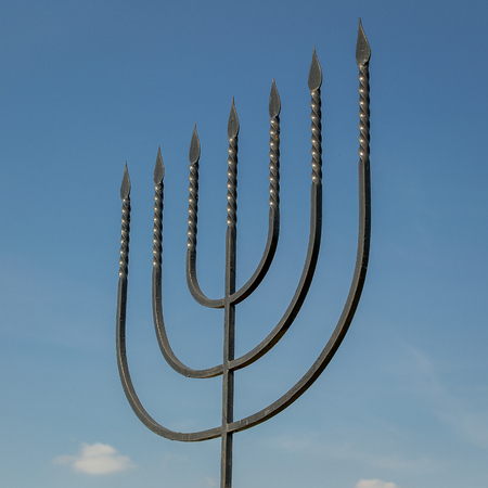 The menorah is a symbol of Judaism, the national-religious sign of Israel. Monument to the victims of the Holocaust in the village of Bogdanovka. Ukraine.のeditorial素材