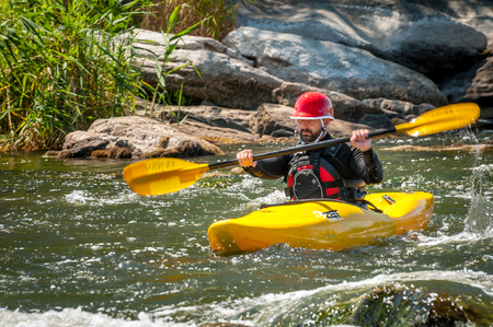 Village Myhiya, Nikolaev region, Ukraine - July 2, 2017: Kayaking on the Southern Bug River in sunny weather. A popular place for extreme recreation and training of rafting and kayaking athletes.のeditorial素材