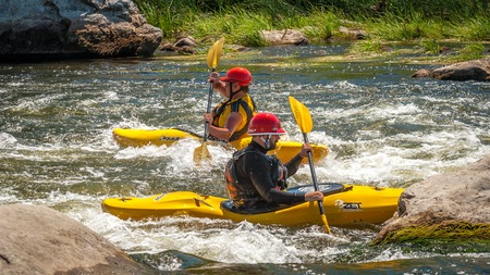 Village Myhiya, Nikolaev region, Ukraine - July 2, 2017: Kayaking on the Southern Bug River in sunny weather. A popular place for extreme recreation and training of rafting and kayaking athletes.のeditorial素材