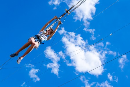 Ukraine, Migea - July 30, 2017: Zipline. A view of a blue sky with white clouds. Extreme and active rest.のeditorial素材