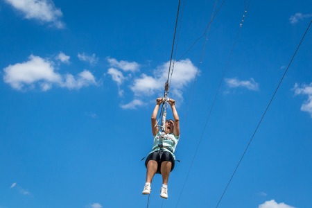 Ukraine, Migea - July 30, 2017: Zipline. A view of a blue sky with white clouds. Extreme and active rest.のeditorial素材