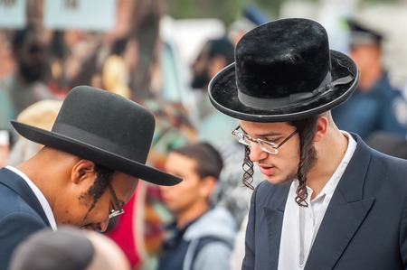 Uman, Ukraine - 2 October 2016: Rosh Hashanah, Jewish New Year 5777. It is celebrated at the grave of Rabbi Nachman. Pilgrims in traditional festive clothes. Conversation between two Hasidic Jews.のeditorial素材