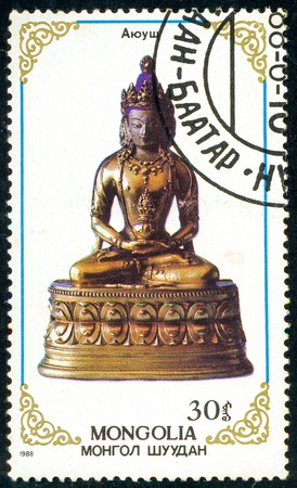 Ukraine - circa 2017: A postage stamp printed in Mongolia shows drawing Ajush statue. Series: Buddhist God Figures. Circa 1988.のeditorial素材
