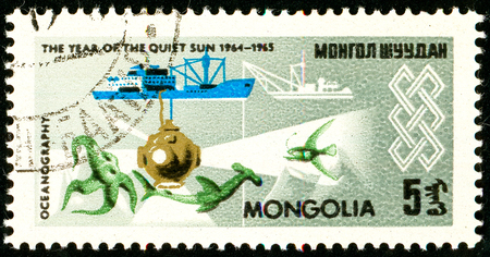 Ukraine - circa 2018: A postage stamp printed in Mongolia shows Devices for studying the ocean: ship, bathyscaphe. Oceanography. Series: International Year of the Sun. Circa 1965.のeditorial素材