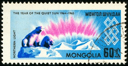 Ukraine - circa 2018: A postage stamp printed in Mongolia shows Polar bears on the ice floe and the northern lights. Series: International Year of the Sun. Circa 1965.のeditorial素材