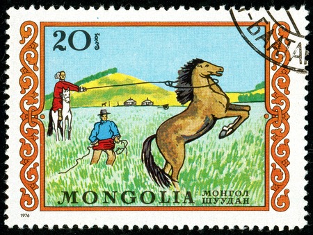 Ukraine - circa 2018: A postage stamp printed in Mongolia shows drawing Horse, Equus ferus caballus and Tamer. Series: International Children Day. Circa 1976.のeditorial素材