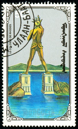 Ukraine - circa 2018: A postage stamp printed in Mongolia show Colossus of Rhodes. Series: 7 Wonders of the Ancient World. Circa 1990.のeditorial素材