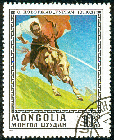 Ukraine - circa 2018: A postage stamp printed in Mongolia show Taming wild horse. Series: Paintings by O. Cevegshava. Circa 1976.のeditorial素材
