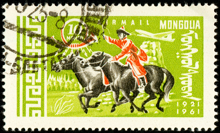 Ukraine - circa 2018: A postage stamp printed in Mongolia show Postman on Horse or Equus ferus caballus. Series: 40 years of Mongolian mail. Circa 1961.のeditorial素材