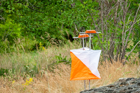 Orienteering. Check point Prism and composter for orienteering. Navigation equipment. The conceptの写真素材