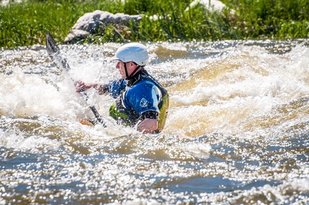 Myhiya, Ukraine - May 1, 2018: Rafting, kayaking. An unidentified man are sailing on his short Dagger whitewater kayak. Extreme sport. Ecological water tourism. Emotions. Water splash close-upのeditorial素材