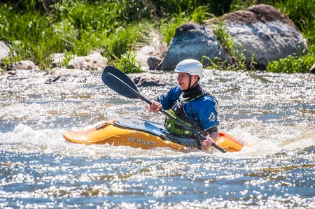 Myhiya, Ukraine - May 1, 2018: Rafting, kayaking. An unidentified man are sailing on his short Dagger whitewater kayak. Extreme sport. Ecological water tourism. Emotions. Water splash close-upのeditorial素材