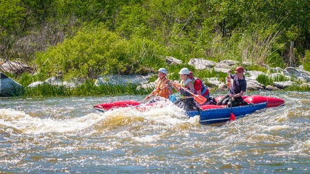 Myhiya, Ukraine - May 1, 2018: Rafting. Merry company of young people sailing on a rubber inflatable boat. Teamwork. Extreme sport. Ecological water tourism. Positive emotions, adrenalineのeditorial素材
