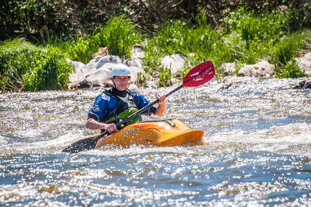 Myhiya, Ukraine - May 1, 2018: Rafting, kayaking. An unidentified man are sailing on his short Dagger whitewater kayak. Extreme sport. Ecological water tourism. Emotions. Water splash close-upのeditorial素材