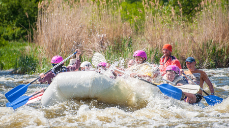 Myhiya, Ukraine - May 1, 2018: Rafting. Merry company of people of different ages sailing on a rubber inflatable boat. Teamwork. Extreme sport. Ecological water tourism. Positive emotions, adrenalineのeditorial素材