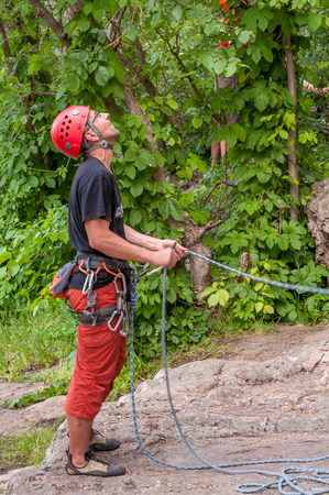 Yuzhnoukrainsk, Ukraine - June 19, 2018: Rock climbing. Young athlete insure their comrades climbing the rock. Extreme sport. Training of mountaineers.のeditorial素材