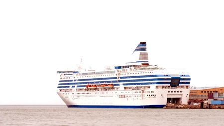 Large white sea ferry stands at the pierの写真素材