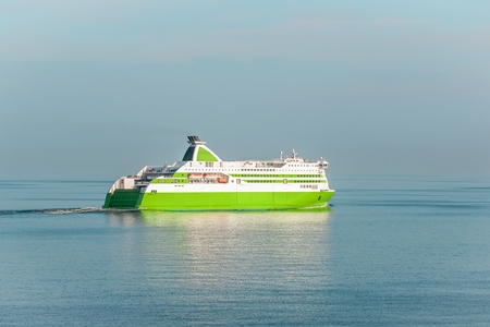 The sea ferry sails on calm waterの写真素材