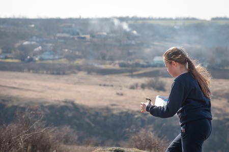 Ukraine, Mykolaiv region - March 9, 2019: orienteering. Traditional annual orienteering competitions, dedicated to the Women's Day on March 8. Athlete teenager girl at a distance of competitionのeditorial素材