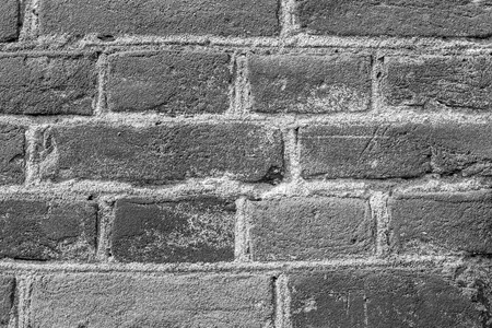 Brick wall close-up. Brick laying on cement mortarの写真素材