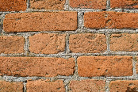 Brick wall close-up. Brick laying on cement mortarの写真素材