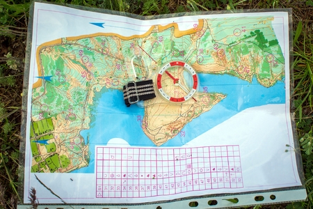 Orienteering. Compass and topographic map. Navigation equipment for orienteering. The conceptの写真素材