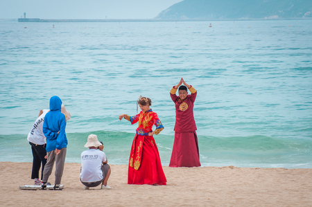 Yalong Bay beach. Backstage wedding photo session of Chinese couples. Newlyweds posing for a wedding photo shoot. Backstage photo session love storyのeditorial素材