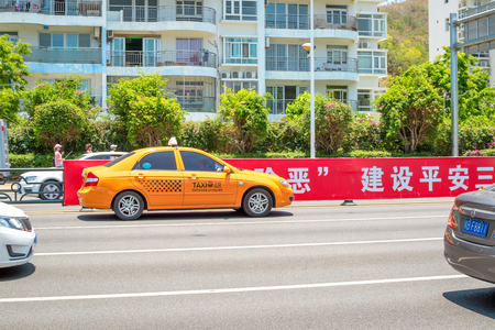 Hainan Island, Sanya, China - May 18, 2019: Taxi. Chinese yellow taxi on the street of Sanyaのeditorial素材