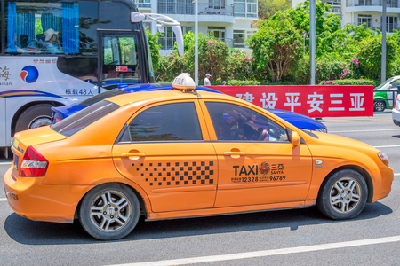 Hainan Island, Sanya, China - May 18, 2019: Taxi. Chinese yellow taxi on the street of Sanyaのeditorial素材