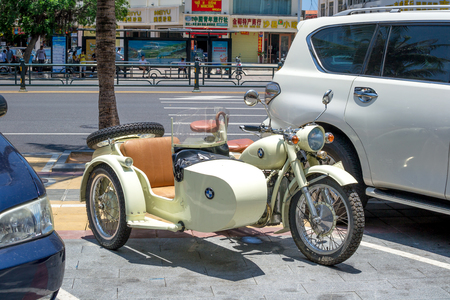 Hainan, Sanya, China - May 18, 2019: Rare motorcycle with a stroller with a BMW logo is parked near the market in the Chinese city of Sanya.のeditorial素材