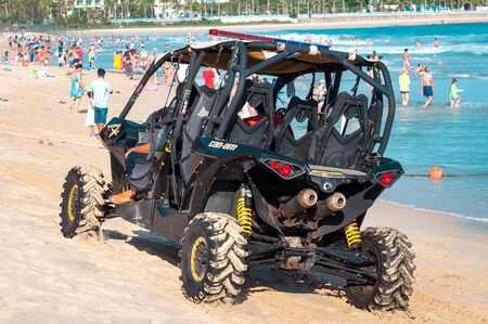 China, Hainan Island, Sanya, Dadonghai Bay - May 16, 2019: Unidentified vehicle drives along the beach of Dadonghai Bayのeditorial素材