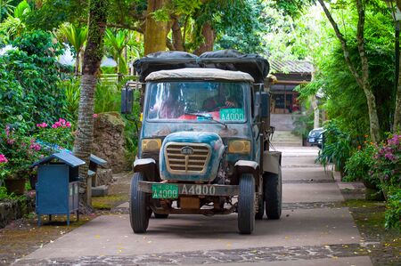 Haikou, Hainan, China - 11 May, 2019: A very old Chinese truck still operates in the Shishan National Crater Park. Rare, exotic, vintage vehicleのeditorial素材