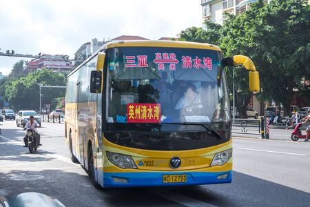Sanya, Hainan island, China - May 15, 2019: Road traffic. A lot of electric cars. Hybrid buses. 90 percent of mopeds are electric. From 2030, only electric transport will be allowed on the island.のeditorial素材