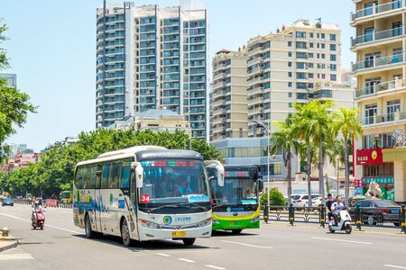 Sanya, Hainan island, China - May 15, 2019: Road traffic. A lot of electric cars. Hybrid buses. 90 percent of mopeds are electric. From 2030, only electric transport will be allowed on the island.のeditorial素材
