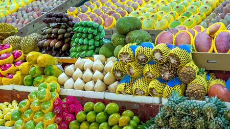 Fresh tropical fruits are on the market window. Healthy, organic food. Banana, pineapple, ananas, durian, Dragon fruit, coconut, mango, mangosteen, rambutanの写真素材